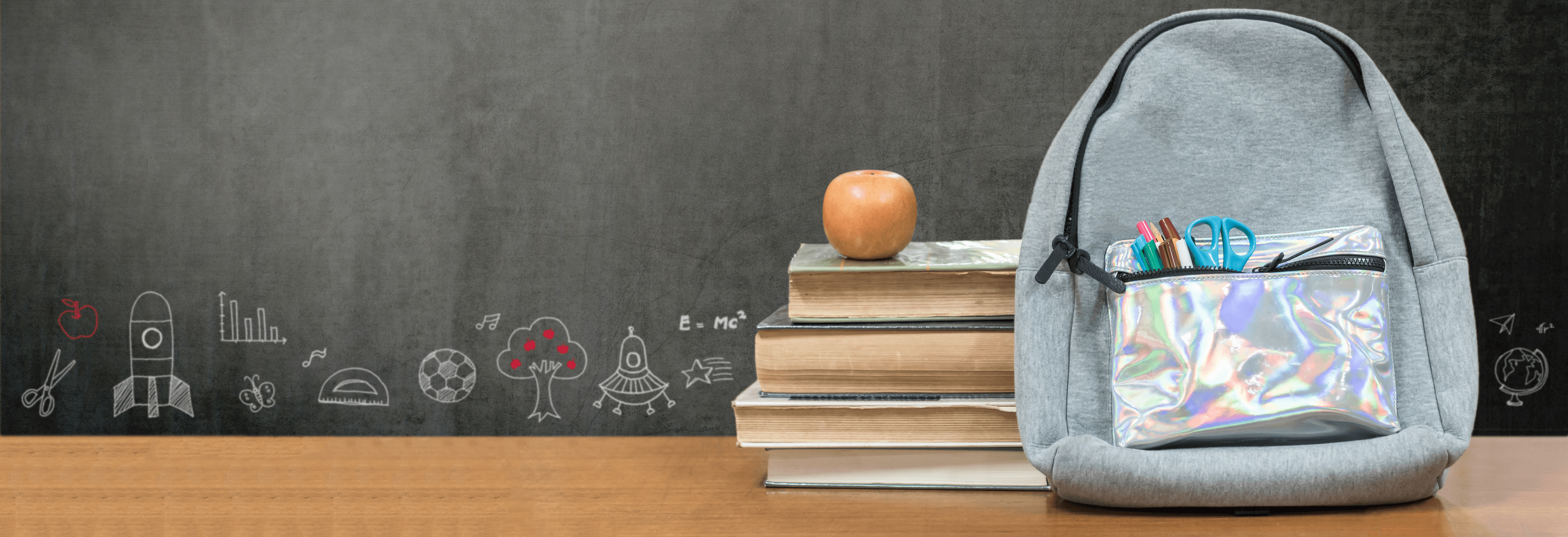 Image of a backpack and books on desk; courtesy of Shutterstock.